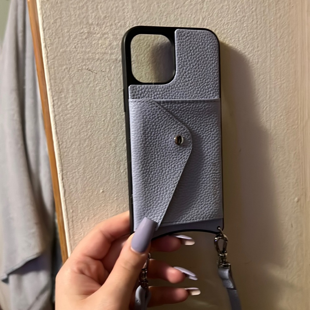 Bandolier leather phone case. Has a card slot, dust bag and cross body strap.